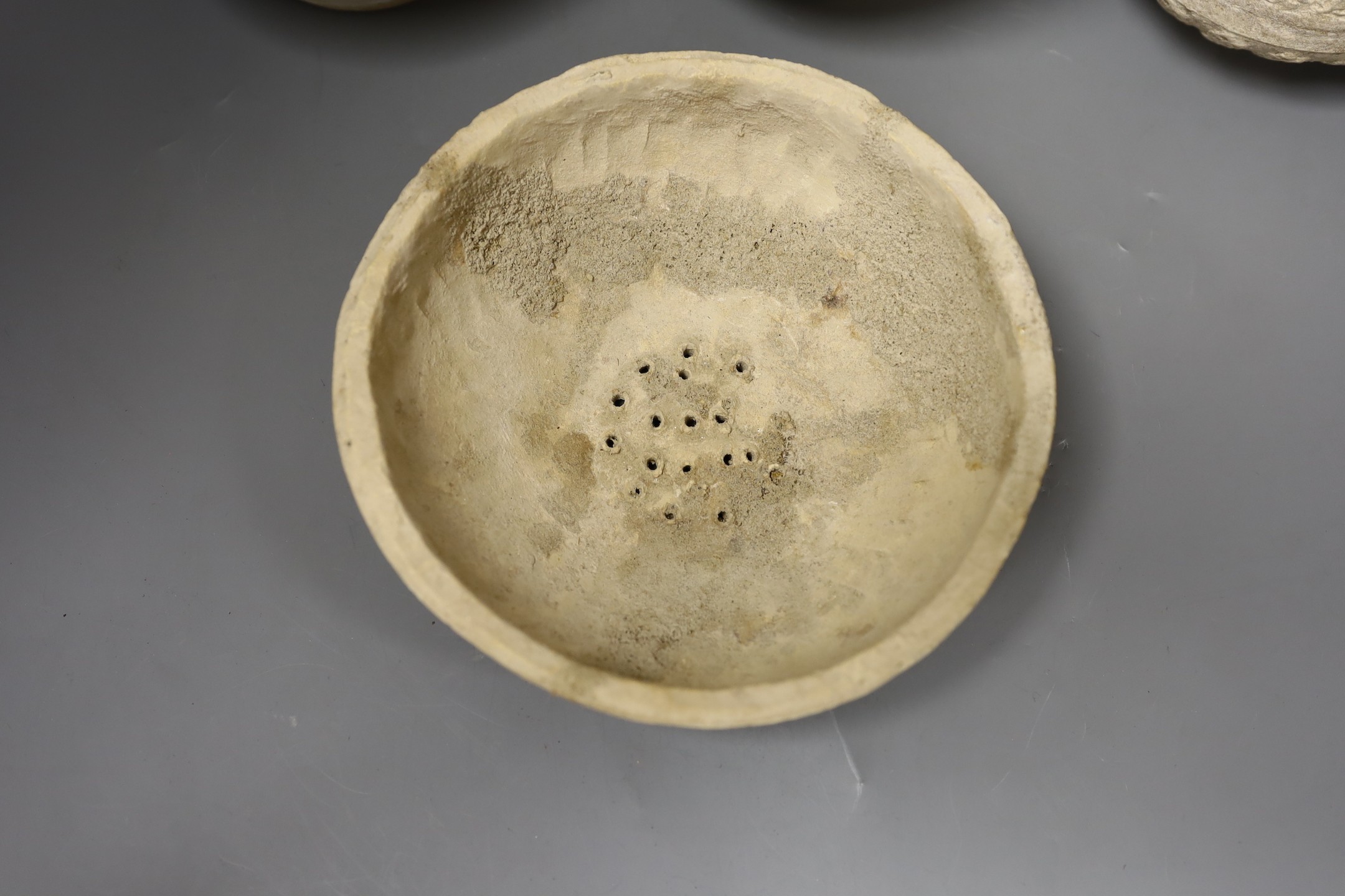 Three Islamic terracotta jugs and a strainer, Middle Eastern, possibly 12th century, tallest 24cm